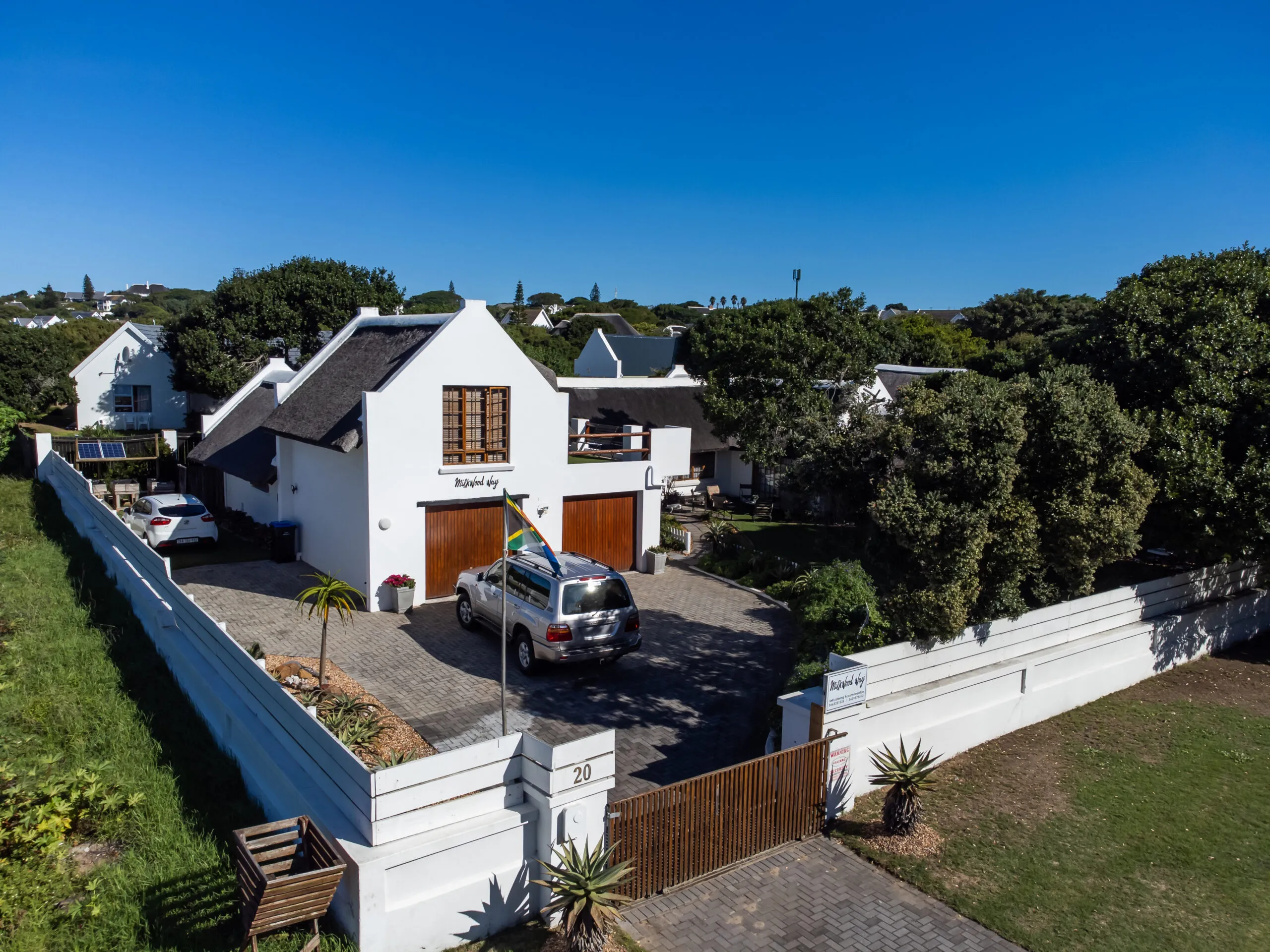 Aerial view of the Milkwood Way cottages and walled garden in St Francis Bay