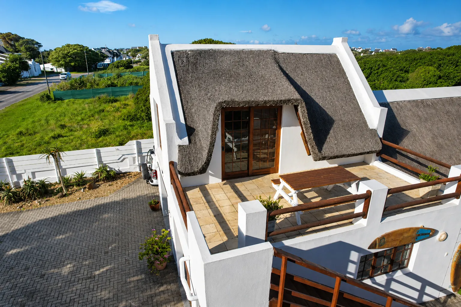 Berry Cottage from above, showing its private thatched verandah and deck