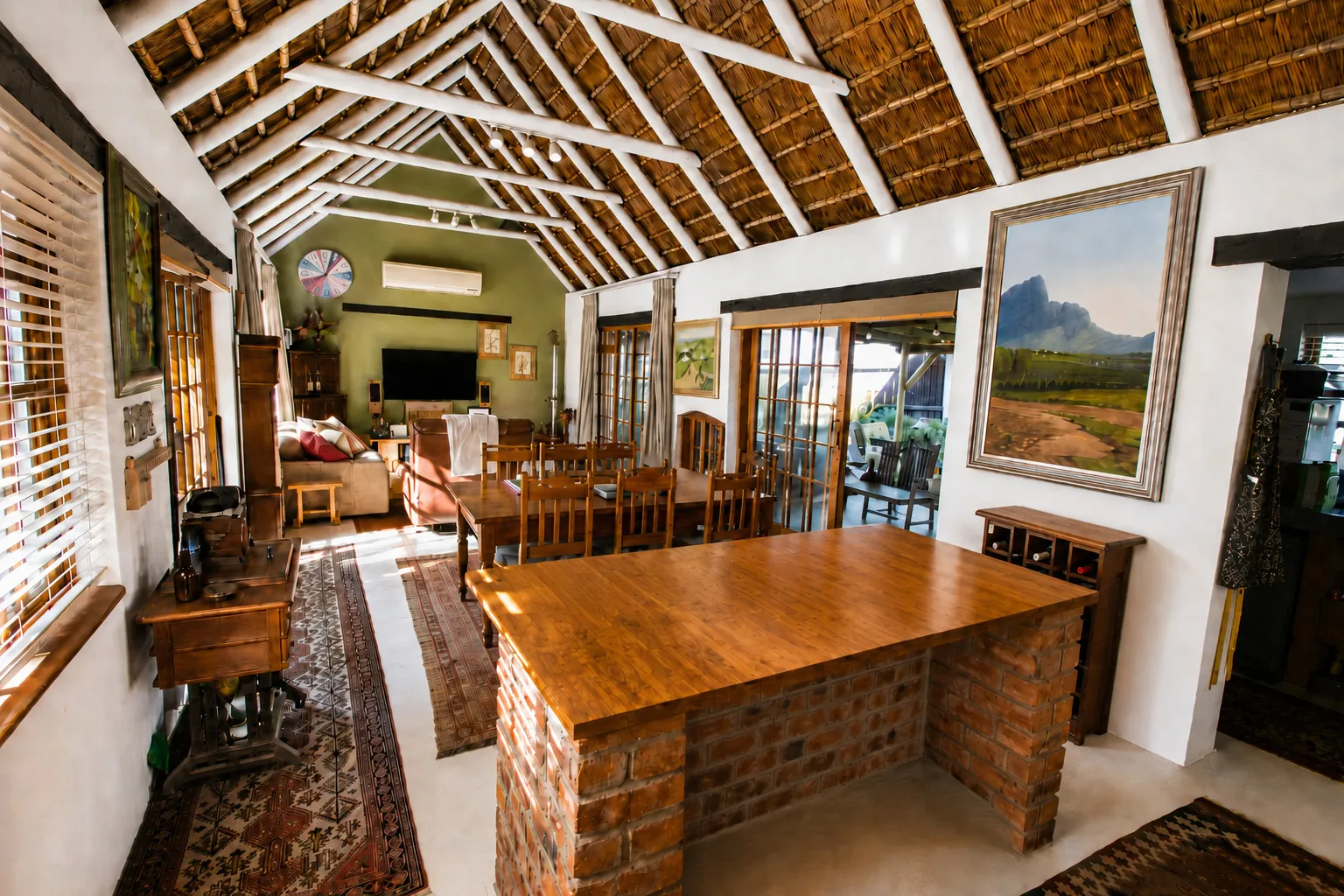 The open-plan kitchen, dining and lounge area, leading out to the covered braai patio